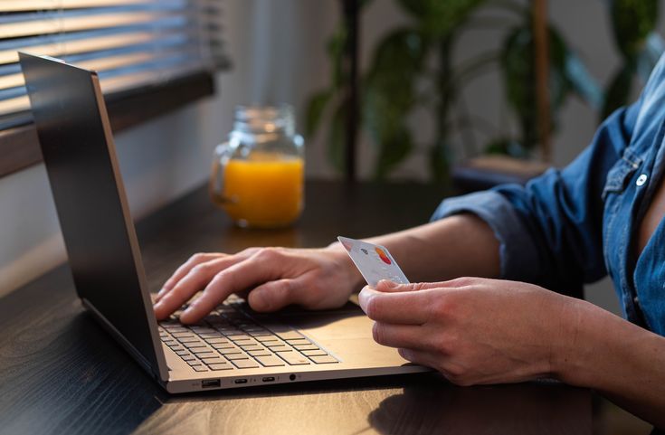 Man inputting card details into laptop